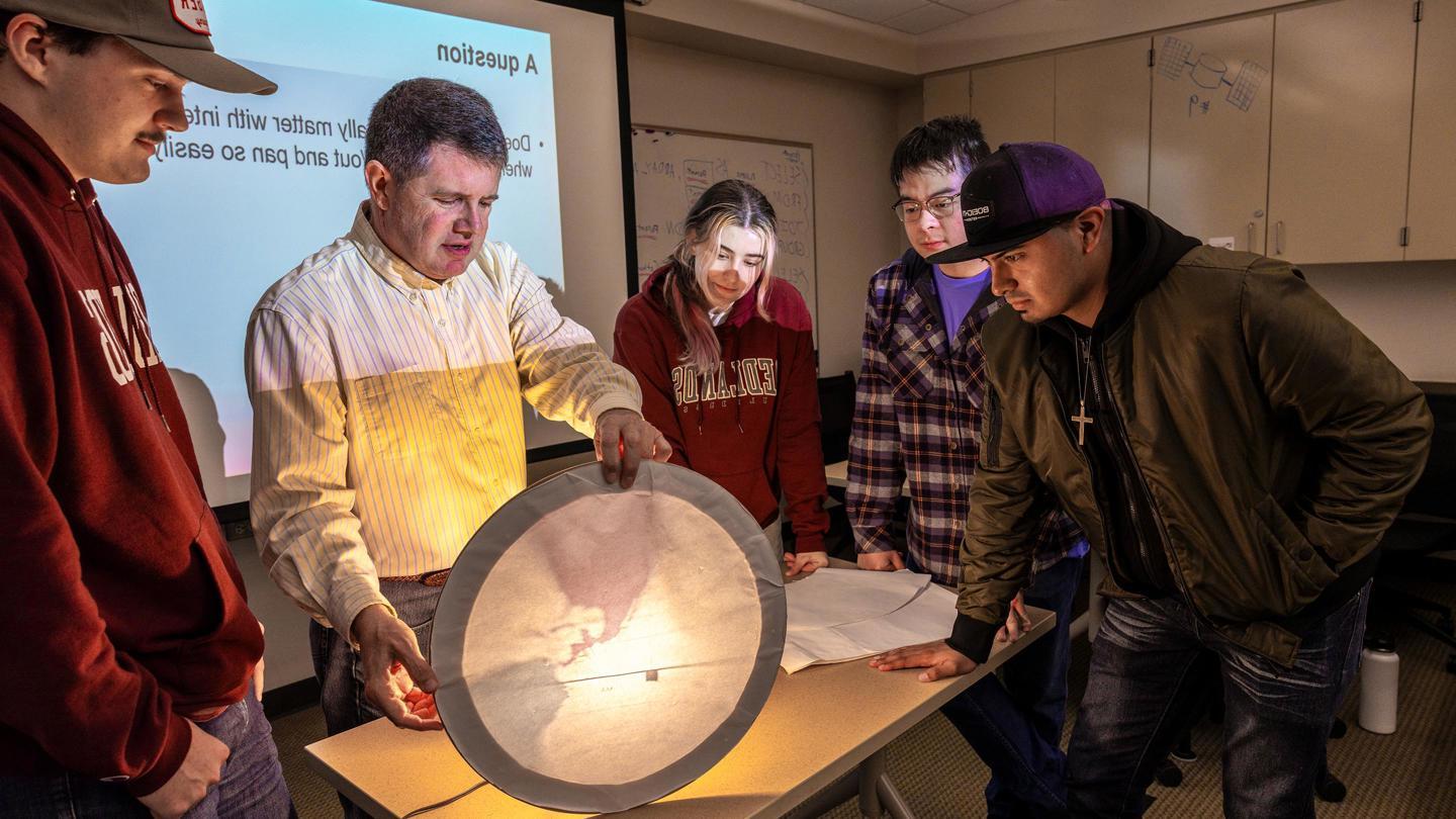 GIS professor teaching a class on light and maps.